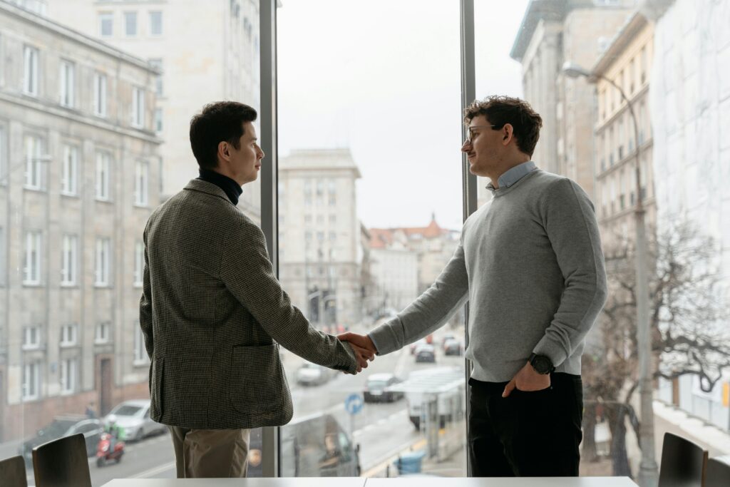 Two salespeople shaking hands.